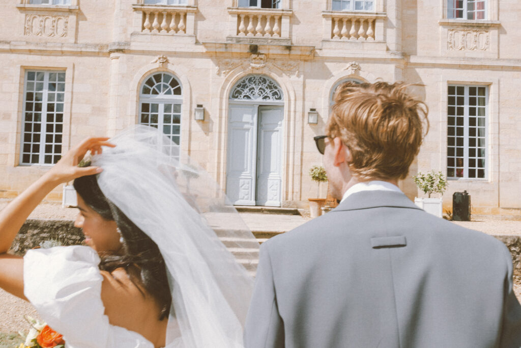 Couple at a Chateau wedding in France, destination wedding, looking at the castle